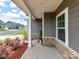 Covered porch featuring stone accents and well manicured landscaping at 3023 Ballester Rd, Fort Mill, SC 29707