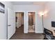Hallway view of a modern home interior, showing entryways to other rooms and a view of the bathroom at 3023 Ballester Rd, Fort Mill, SC 29707