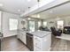 Open concept kitchen island with a stainless steel dishwasher connecting to a dining area and living room at 3023 Ballester Rd, Fort Mill, SC 29707