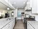 Spacious kitchen features stainless steel appliances, gray cabinets, granite countertops, and an island at 3023 Ballester Rd, Fort Mill, SC 29707