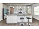A modern kitchen featuring gray cabinets, a granite island with seating, and stainless steel appliances at 3023 Ballester Rd, Fort Mill, SC 29707