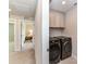 Convenient laundry room with a front loading washer and dryer and upper cabinets for storage at 3023 Ballester Rd, Fort Mill, SC 29707