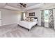 Serene main bedroom suite offers a tray ceiling, plush carpet, and natural light from the large windows at 3023 Ballester Rd, Fort Mill, SC 29707