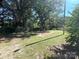 A lush backyard with mature trees offering ample shade and an unfinished concrete foundation at 345 Mountain View St, Gastonia, NC 28052