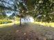 A shaded backyard features a swing set on a lawn, perfect for play at 345 Mountain View St, Gastonia, NC 28052