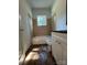 Bathroom features tile flooring, tile walls and white fixtures at 345 Mountain View St, Gastonia, NC 28052