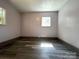 Empty bedroom with wood floors, neutral walls, natural lighting and modern trim at 345 Mountain View St, Gastonia, NC 28052