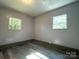 Bedroom featuring hardwood floors, natural light from two windows and neutral paint at 345 Mountain View St, Gastonia, NC 28052
