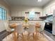 Open kitchen with white cabinets, modern appliances, and adjacent dining area at 345 Mountain View St, Gastonia, NC 28052