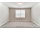 Neutral bedroom with soft carpet, window with blinds, and ample natural light at 3936 Cheyney Park Dr, Charlotte, NC 28269