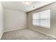 Bedroom featuring neutral carpet, a window with blinds, and a clean, simple design at 3936 Cheyney Park Dr, Charlotte, NC 28269