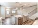 Open-concept kitchen with stainless steel appliances, island with sink, and hardwood flooring at 3936 Cheyney Park Dr, Charlotte, NC 28269