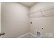 A functional laundry room features neutral walls and ample shelving for organized storage at 3936 Cheyney Park Dr, Charlotte, NC 28269