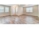 Open living room with lots of natural light, wood-look flooring, and a view of the front entrance at 3936 Cheyney Park Dr, Charlotte, NC 28269
