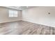 Bright and spacious room features wood-look floors, a large window, and neutral wall color at 3936 Cheyney Park Dr, Charlotte, NC 28269