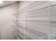 A well-organized walk-in closet has several levels of metal shelving against a neutral wall at 3936 Cheyney Park Dr, Charlotte, NC 28269