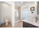 Well-lit bathroom featuring a double sink vanity and tiled walk-in shower with modern fixtures at 40154 Crooked Stick Dr, Lancaster, SC 29720