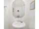 Neat half bathroom with white pedestal sink, a octagonal mirror and wall decorations at 40154 Crooked Stick Dr, Lancaster, SC 29720