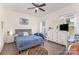 Bright bedroom with a ceiling fan, a large dresser, and ample natural light from the windows at 40154 Crooked Stick Dr, Lancaster, SC 29720