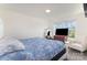 Cozy bedroom with a blue patterned bedspread, chair, and natural light from the windows at 40154 Crooked Stick Dr, Lancaster, SC 29720