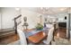 Inviting dining room seamlessly connects to the kitchen, featuring a stairway and gleaming hardwood floors at 40154 Crooked Stick Dr, Lancaster, SC 29720