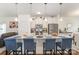Well-equipped kitchen with island seating, stainless steel appliances, and ample counter space with view to living room at 40154 Crooked Stick Dr, Lancaster, SC 29720