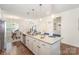 Bright, open kitchen features a granite island with pendant lighting, stainless appliances, and hardwood floors at 40154 Crooked Stick Dr, Lancaster, SC 29720