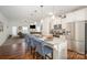 This open concept kitchen boasts granite countertops, stainless appliances, and a breakfast bar with seating at 40154 Crooked Stick Dr, Lancaster, SC 29720