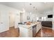 Well-lit kitchen island with granite countertops, stainless appliances, and seamless access to other rooms at 40154 Crooked Stick Dr, Lancaster, SC 29720