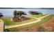 Beautiful lakeside area with a picnic table, landscaping, and docks for boats at 40154 Crooked Stick Dr, Lancaster, SC 29720