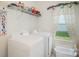 Practical laundry room with a washer, a dryer, and storage shelves at 40154 Crooked Stick Dr, Lancaster, SC 29720