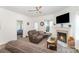 Cozy living room features a fireplace, plush reclining furniture, and plenty of natural light at 40154 Crooked Stick Dr, Lancaster, SC 29720