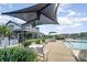 Community pool area with lounge chairs and shaded tables offering relaxation near the water at 40154 Crooked Stick Dr, Lancaster, SC 29720