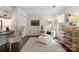 A sunlit bedroom/office space features a chaise lounge, desk and chair at 5011 Sharon Rd # Q, Charlotte, NC 28210