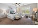 Bright and airy bedroom with a ceiling fan, natural light, and stylish decor at 5011 Sharon Rd # Q, Charlotte, NC 28210