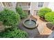 Overhead courtyard view of a serene fountain surrounded by lush greenery and brick paving at 5011 Sharon Rd # Q, Charlotte, NC 28210