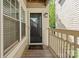 Inviting entryway with a 'Hello' mat, glass storm door and natural light streaming through a window at 5011 Sharon Rd # Q, Charlotte, NC 28210