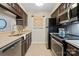 Functional kitchen featuring stainless steel appliances, tile flooring, and ample cabinet space at 5011 Sharon Rd # Q, Charlotte, NC 28210