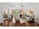 Bright living room with hardwood floors, fireplace, and a sliding glass door to a balcony at 5011 Sharon Rd # Q, Charlotte, NC 28210