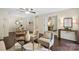 Cozy living room with hardwood floors, comfortable seating, and seamless access to the dining area and bonus room at 5011 Sharon Rd # Q, Charlotte, NC 28210
