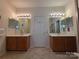 Well-lit bathroom featuring double vanities and modern lighting fixtures at 6017 Lowergate Dr, Waxhaw, NC 28173