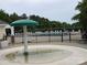 Community pool area with lounge chairs, umbrellas, and surrounding greenery, offering a relaxing environment at 6017 Lowergate Dr, Waxhaw, NC 28173