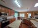 Modern kitchen featuring granite countertops, stainless steel appliances, and wooden cabinets at 6017 Lowergate Dr, Waxhaw, NC 28173