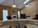 Inviting living room featuring a vaulted ceiling, cozy fireplace, and natural light at 6017 Lowergate Dr, Waxhaw, NC 28173