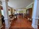 Open-concept living and dining area featuring elegant columns and gleaming hardwood floors at 6017 Lowergate Dr, Waxhaw, NC 28173