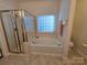 Bright bathroom showcasing a soaking tub and separate shower at 6017 Lowergate Dr, Waxhaw, NC 28173