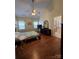 Comfortable main bedroom with vaulted ceiling, wood floors, and ensuite bathroom at 6017 Lowergate Dr, Waxhaw, NC 28173