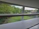 Window view of the lush, green backyard through closed blinds at 6017 Lowergate Dr, Waxhaw, NC 28173