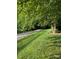 Lush yard features gravel path and mature trees at 6017 Lowergate Dr, Waxhaw, NC 28173