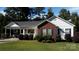 Inviting single-story home with a well-manicured lawn and convenient covered parking at 625 Wildwood Dr, Rock Hill, SC 29730